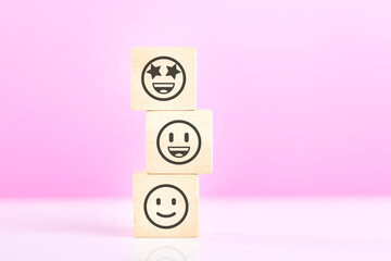 A Wooden blocks featuring smiley and sad face stickers, symbolizing the concept of choosing between...