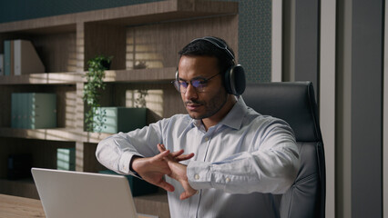 Indian businessman stretching hands fingers start work laptop Arabian man American office worker...