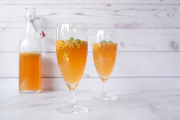 Kombucha second fermentation with passion fruit flavor. home-brew passion fruit flavor Kombucha in tall glasses on white table background..