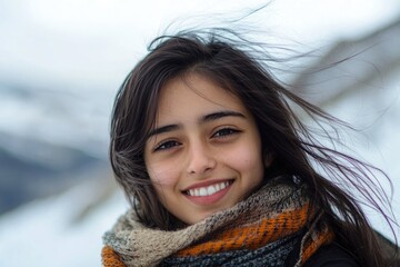 A woman wearing a scarf walks in a snowy environment, great for winter or cold weather scenes