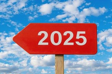 A vibrant red sign pointing to the future, labeled with the year 2025 against a clear blue sky with clouds.