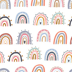 Seamless childish pattern with hand drawn rainbow in cartoon style. design for Newborn apparel, textiles, and wallpaper. Vector illustration