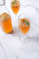 Kombucha second fermentation with passion fruit flavor. home-brew passion fruit flavor Kombucha in tall glasses on white table background..