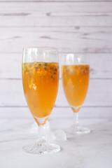 Kombucha second fermentation with passion fruit flavor. home-brew passion fruit flavor Kombucha in tall glasses on white table background..