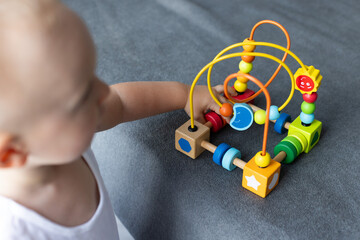 Baby with educational toy, Cognitive skills, Montessori activity. Selective focus.