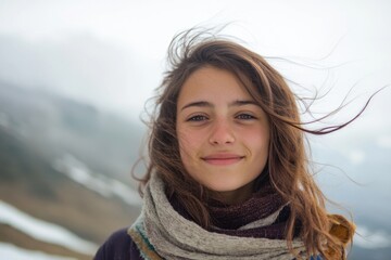 Fototapeta premium A woman stands in snowy weather wearing a scarf, perfect for winter scenes or cold climate settings
