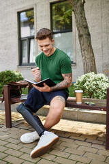 Obraz premium A young and handsome man with a prosthetic leg sits on a bench, smiling as he writes in a notebook.