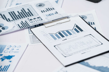 Piles of business intelligence paper or BI financial report and financial data visualization on paperwork for business analytic marketing and strategic planning at office desk. Prudent