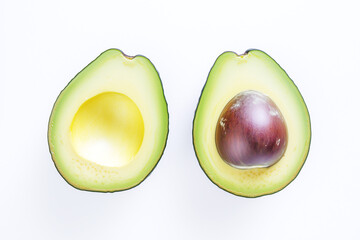 Two avocados are cut in half. One half is yellow and the other half is green, clean food.