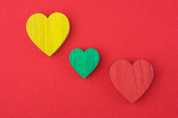 Obraz premium Traffic light green, yellow, red hearts on the red background.