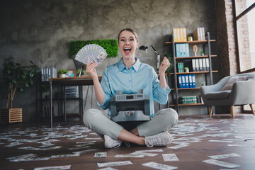 Photo of cheerful lucky lady recruiter dressed shirt eyewear rising fists counting dollars indoors...