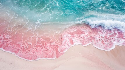Obraz premium Waves gently lapping at the pink sandy beach under a bright sky, creating a picturesque seaside view in a tropical paradise