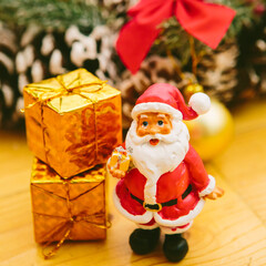 Obraz premium Christmas wreath including a small Santa Claus figurine and a golden bauble.