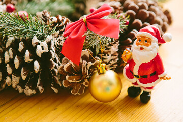 Christmas wreath including a small Santa Claus figurine and a golden bauble.