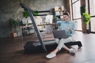 Photo of happy positive lady recruiter dressed shirt headphones sitting treadmill communicating...