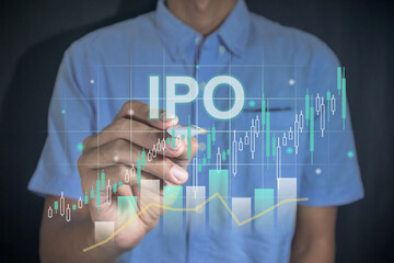 IPO or initial public offering concept. Man holding a pen with virtual stock graph.