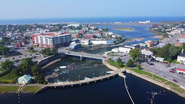 Aerial view of Matane town, Matane River, Mathieu D&rsquo;Amour Dam with salmon migratory pass meeting the Saint Lawrence River in Quebec on the Gasp&eacute; Peninsula