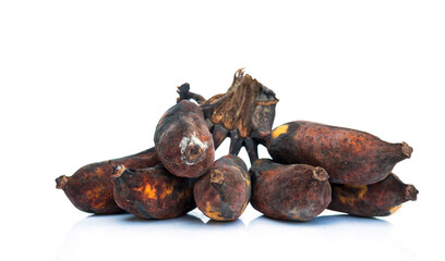 Very ripe bananas with black skin on a white background.
