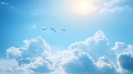Fototapeta premium Light blue sky with fluffy clouds and birds flying in the distance, providing a sense of peace.