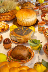 Assortment of baked bread and buns on the table in a bakery. Traditional Romanian bread on the table in Romania.