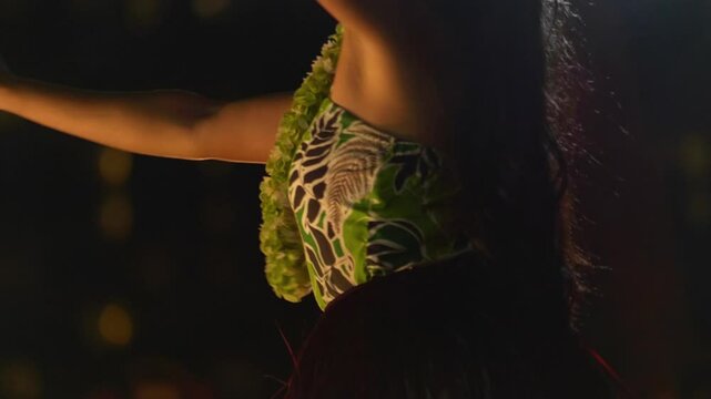 Hula dancer performing with red feathered poi balls in Hawaii, USA in 4K slow motion 60fps