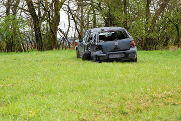 Abandoned car standing by the road after the traffic accident. Completely destroyed and wrecked.  