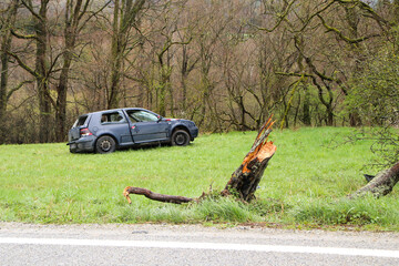 Abandoned car standing by the road after the traffic accident. Completely destroyed and wrecked.  