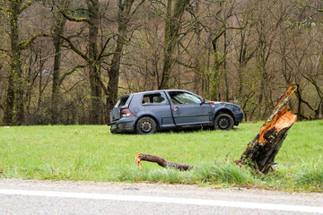 Abandoned car standing by the road after the traffic accident. Completely destroyed and wrecked.  