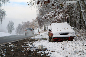 Abandoned car standing by the road. Maybe after the traffic accident or failure. Symbolises also the dangerous conditions in winter with ice, snow and snatch.