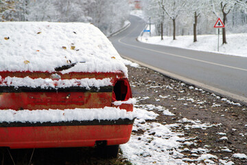 Abandoned car standing by the road. Maybe after the traffic accident or failure. Symbolises also the dangerous conditions in winter with ice, snow and snatch.