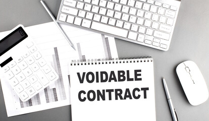  Voidable contract concept with calculator, keyboard, notebook, and pen on an office desk