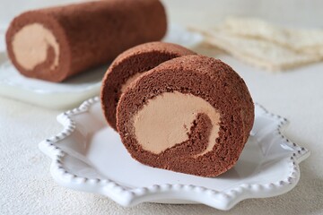 Tasty roll cake, sponge roll, Swiss roll stuffed with cream cheese ,decorated with fresh raspberries.
