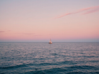 Fototapeta premium Solitary Sailboat on Calm Seas