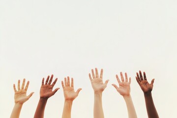 Obraz premium Raised hands of different skin colors against clear sky.