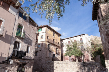 Charming traditional houses in a rustic Spanish village under a bright blue sky