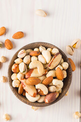 Healthy mix nuts on wooden background. Almonds, hazelnuts, cashews, peanuts, pistachios, Brazil nuts