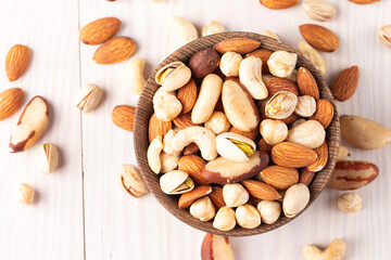 Healthy mix nuts on wooden background. Almonds, hazelnuts, cashews, peanuts, pistachios, Brazil nuts