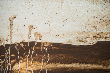 A painting of a desert with a few trees and a few people. The painting is very dark and has a moody...