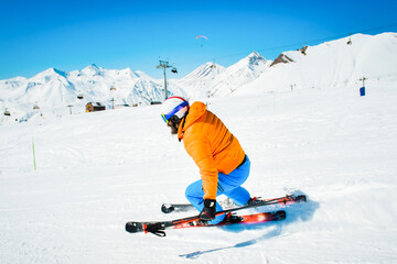 Freeride skier riding in the scenic mountains with blue sky