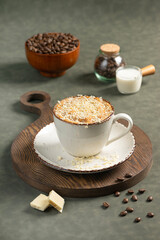 White Chocolate Mocha with Shaved White Chocolate: A ceramic cup of white chocolate mocha topped with a layer of shaved white chocolate. Served on a rustic wooden board, accompanied by coffee beans 