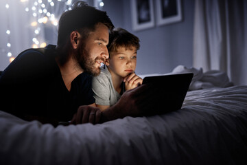 Bonding, dad and son with tablet, bedroom and watching of cartoons, blanket and night in home....