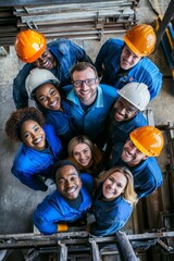 Diverse group of happy male and female workers smiling together in safety helmets.