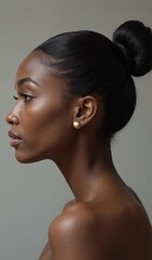 Profile of elegant woman with sleek hairstyle and gold earrings
