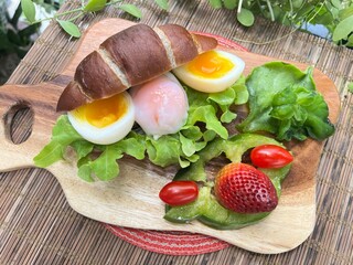 Soft-Boiled Egg Burger in truffle Salt Bread, served with mixed salad