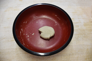 Soba noodles, thin and earthy, are made from buckwheat flour, offering a nutty flavor. Served hot in broth or chilled with dipping sauce. Image of preparing home made dough.