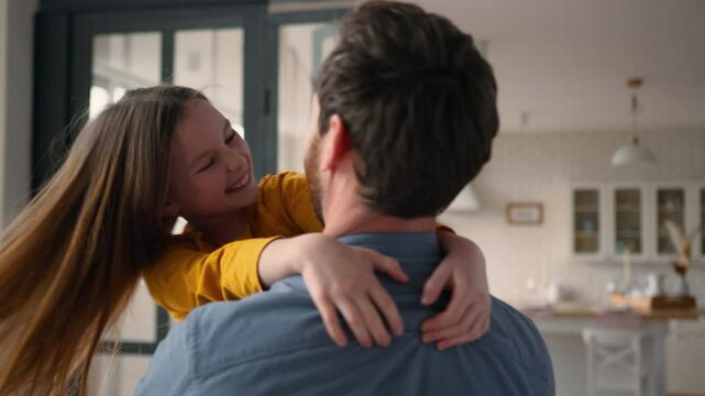 Happy Caucasian family positive man dad male parent daddy holding spinning little girl child kid at home. Loving father hugging cuddle daughter touching noses smile laughing custody bonding parenthood