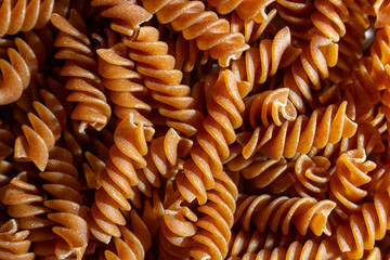 Uncooked Whole Grain Fusilli Pasta: A Culinary Canvas of Whole Wheat Spirals, Creating a Lively and...