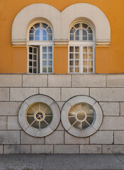 Round windows on yellow fasade 