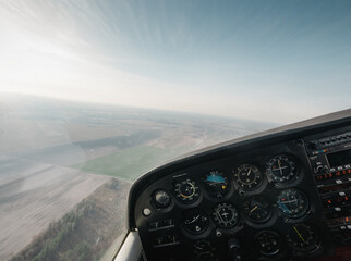 Point of view: piloting small aircraft. Cockpit of light utility aircraft - instrument panel with...