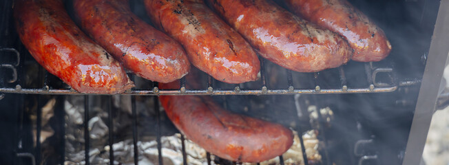Looking down at sausages in smoker box 